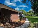 Brick home featuring a landscaped side yard and a paved walkway at 225 Second St, Bowdon, GA 30108
