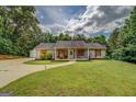 Charming single-story home with a large front yard, long drive and welcoming curb appeal at 527 Malcom Rd, Covington, GA 30014