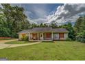 Attractive single-story home featuring a classic design and a well-manicured front lawn at 527 Malcom Rd, Covington, GA 30014