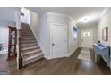 Spacious hallway featuring hardwood floors, staircase, and access to multiple rooms at 3018 Patriots Square, Marietta, GA 30064