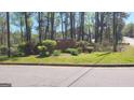 Welcome to Peachcrest Trace, beautiful landscaping enhances the community entrance at 1611 Cobbs Creek Ln, Decatur, GA 30032