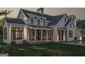 Charming farmhouse exterior featuring rocking chairs on the front porch at 120 Godby Dr, Fayetteville, GA 30215