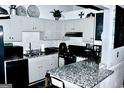 Cozy kitchen featuring gray cabinets, granite countertops, and modern appliances for efficient meal preparation at 3253 Blackfoot Ln, Rex, GA 30273