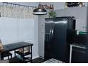 Bright kitchen with stainless steel refrigerator, pendant lighting, and ample cabinet space at 3253 Blackfoot Ln, Rex, GA 30273