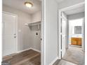 Hallway view showcasing gray floors, fresh paint, and a glimpse of a bathroom with wood vanity at 2039 Faith Cv, Atlanta, GA 30349