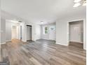 Bright living room featuring modern gray flooring, neutral walls, and ample natural light through the front door at 2039 Faith Cv, Atlanta, GA 30349