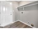 Mud room featuring wood floors, a white exterior door, and a shelf for storage solutions at 2039 Faith Cv, Atlanta, GA 30349
