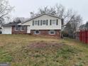 Inviting two-story home with brick accents, a front yard and budding trees at 5793 Springfield Pl, Ellenwood, GA 30294