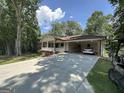 Cozy single-story home with a covered carport and a charming porch, surrounded by mature trees at 370 Rosetta Nw Ln, Conyers, GA 30012