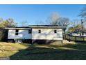 Side view of home with a visible painted concrete foundation at 225 Bell St, Covington, GA 30016