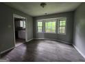 A well-lit dining area featuring large windows and updated flooring at 6679 Cameron Rd, Morrow, GA 30260