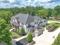 Expansive home featuring an entertainment patio, manicured landscaping, and a private driveway at 30 Dorset Ct, Sharpsburg, GA 30277