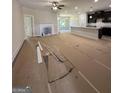 Spacious living room with fireplace, seamlessly connected to a kitchen and dining area with abundant natural light at 11156 Cornerstone Way, Hampton, GA 30228