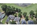 Aerial view showcasing luxurious homes in a golf community with lush green landscape and lake at 103 Golf Terrace Dr, Stockbridge, GA 30281