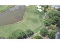 Scenic aerial view of the golf course with a pond and lush green landscape in an upscale community at 103 Golf Terrace Dr, Stockbridge, GA 30281
