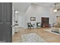 Inviting living room with high ceilings, wood floors, a cozy seating area, and decorative accents and furnishings at 106 Lanyard Bnd, Peachtree City, GA 30269