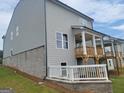 The back of a gray home showing the deck and a white fence barrier at 38 Avian Way # 126B, Auburn, GA 30011