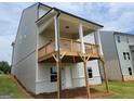 View of back porch with wood columns and a wood railing overlooking the backyard at 40 Avian Way # 127B, Auburn, GA 30011