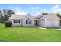 Well-kept single-story home with a lush green lawn and a welcoming facade at 11102 Hunters Ln, Hampton, GA 30228