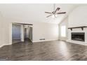 Spacious living room featuring a fireplace, neutral walls, and modern gray floors at 11102 Hunters Ln, Hampton, GA 30228
