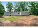 Exterior of the home showing the length of the structure on green grass at 273 Ridge Dr, Villa Rica, GA 30180