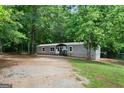 Home exterior surrounded by mature trees and a natural landscape at 273 Ridge Dr, Villa Rica, GA 30180