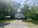 View of the white detached garage with a driveway and parking space for vehicles at 4109 Francis Ne St, Covington, GA 30014