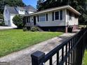 Classic single-story home with a well-maintained lawn and walkway, perfect for comfortable living at 1511 Walker Ave, Atlanta, GA 30337