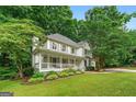 Lovely two-story home featuring a spacious front porch and lush green lawn with mature trees at 4645 Villa Ridge Ne Rd, Marietta, GA 30068