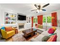 Cozy living room with built-in shelves, fireplace, large windows, and comfortable seating at 4645 Villa Ridge Ne Rd, Marietta, GA 30068