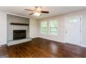Inviting living room with a striking gray brick fireplace, wood floors, and bright windows at 64 Acorn Dr, Dallas, GA 30157