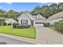 Charming one-story home features a well-manicured lawn, garage and beautiful shutters at 2118 Cherry Tree Ln, Peachtree City, GA 30269