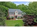 Traditional brick home with manicured landscaping and mature trees surrounding the property at 1120 Upchurch Rd, Mcdonough, GA 30252