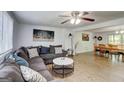 Open-concept living room featuring a large sectional, modern decor, and abundant natural light at 405 Abbey Rd, Peachtree City, GA 30269