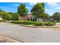 Charming brick home on a corner lot with mature trees and landscaped front yard at 105 Roxbrough Ln, Fayetteville, GA 30215