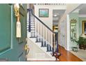 Inviting foyer with hardwood floors, staircase, and stylish decor at 105 Roxbrough Ln, Fayetteville, GA 30215