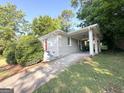 Charming brick home featuring a covered carport and a bright red front door at 2103 Keheley Dr, Decatur, GA 30032