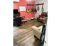 Entertainment room with hardwood floors, guitars hanging on the wall, and comfortable seating area at 120 Alfred Dr, Carrollton, GA 30116