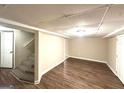 A finished basement featuring new wood floors and a carpeted staircase at 3456 Spring Cir, Decatur, GA 30032