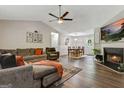 Spacious living room featuring hardwood floors, a cozy fireplace, and comfortable furnishings, perfect for relaxation at 394 Thornbrooke Dr, Hiram, GA 30141