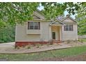 Inviting home with well-manicured lawn, walkway, and cozy front porch entrance at 4135 Coursey Lake Rd, Douglasville, GA 30135