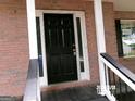 Front door showcasing a modern entrance with a black door and sidelights at 2225 Blue Ridge Ln, Conyers, GA 30012