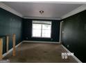 Empty living room with a window and dark green walls ready for personalization at 2225 Blue Ridge Ln, Conyers, GA 30012