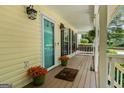 Inviting front porch, featuring potted flowers, a swing, and a well-maintained wood deck at 537 Country Lake Dr, Mcdonough, GA 30252