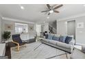 Spacious living room features a ceiling fan, with hardwood floors and a cozy seating area at 733 Wexford Cove Way, Mableton, GA 30126