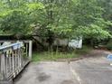 Backyard concrete patio with foliage and greenery surrounding a detached structure at 11591 Turner Rd, Hampton, GA 30228