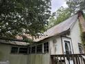 This is the front exterior of the property featuring a small porch and interesting decor at 11591 Turner Rd, Hampton, GA 30228