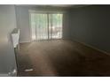 Open living room featuring sliding door access to the outdoors, with a fireplace and neutral wall color at 7 Willowick Dr, Lithonia, GA 30038
