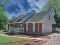 Attractive brick home featuring an attached garage and landscaped front yard at 902 Sweetbay Ct, Stockbridge, GA 30281