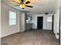 Bright living room with updated flooring and a ceiling fan for comfort at 1764 Cahoon Sw St, Atlanta, GA 30310